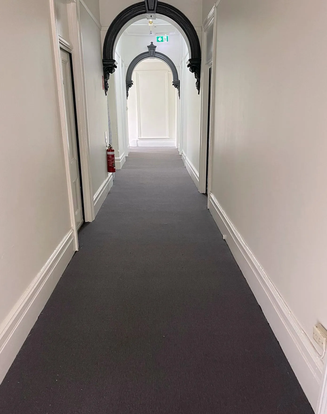Gray carpet installation in a long hallway in New York