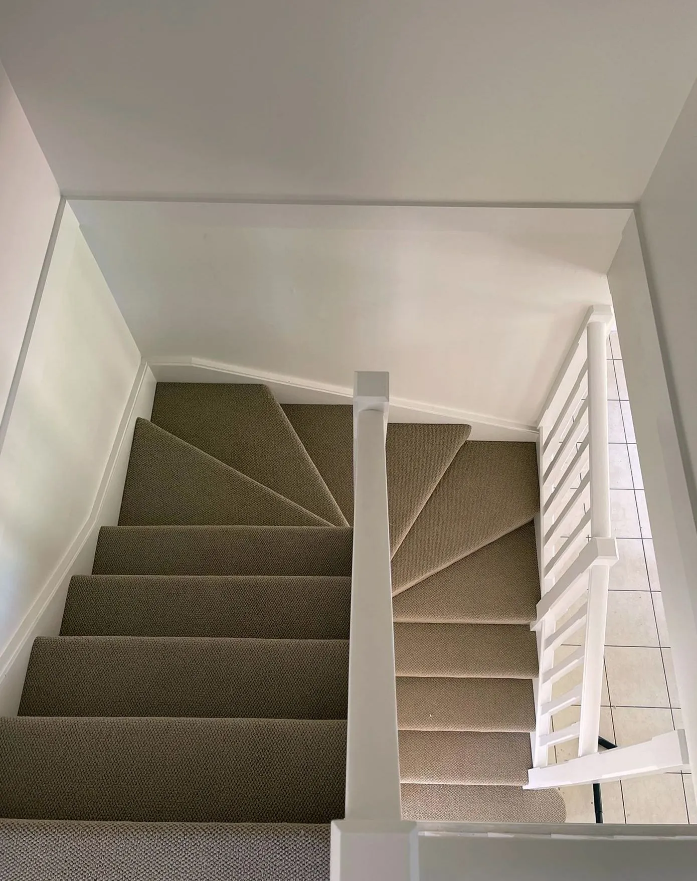 Stair carpet installation on a winding staircase in New York
